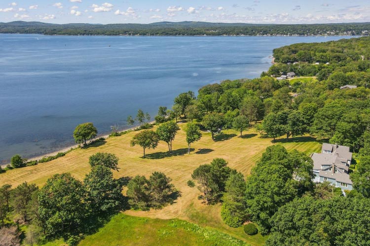 A large waterfront home and property in Belfast, Maine. The home sits far back from the shoreline and features an incredible view of the areas surrounding the water.
