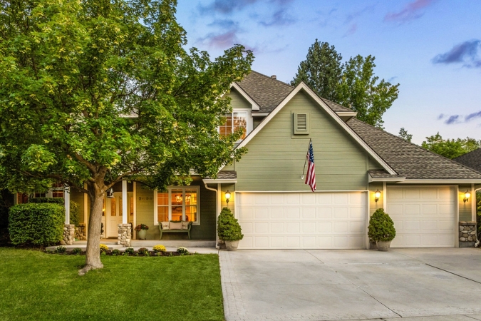 Classic East End home in one of the best neighborhoods in Boise with a two-car garage, a tree in the front yard, and a well-maintained lawn.