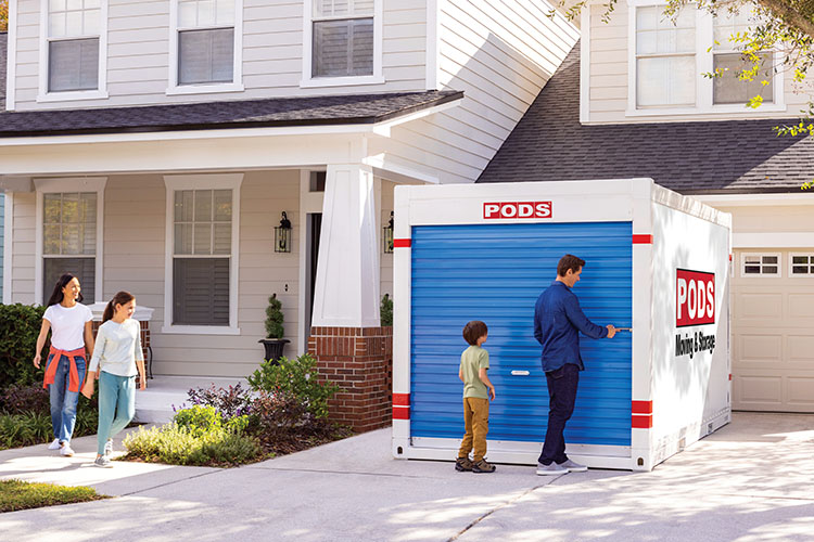 A family unlocking their PODS container as they move into their new Huntsville home