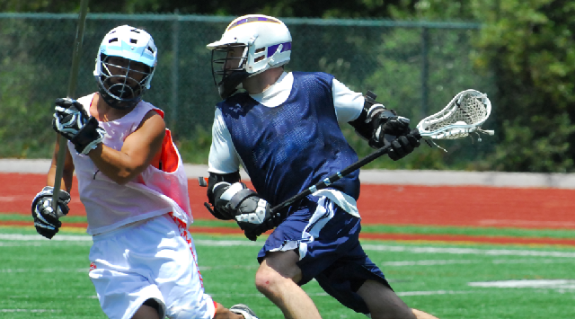 Two Lacrosse players running