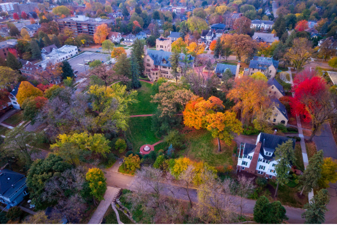 An aerial view of neighborhoods in Rochester, MN surrounded by fall foliage.