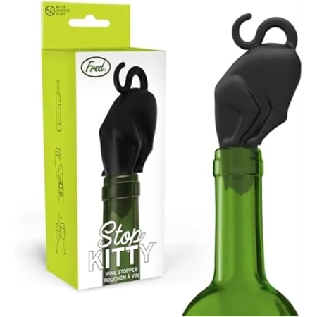 Black silicone cat-shaped wine bottle stopper with a curved tail handle, shown inserted into a green wine bottle next to its green-and-white retail packaging labeled “Stop Kitty.”