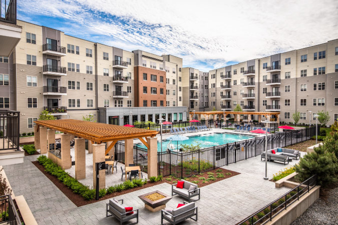 Exterior view of the community pool and courtyard, surrounded by apartments at 145 Front at City Square in Worcester, Massachusetts.