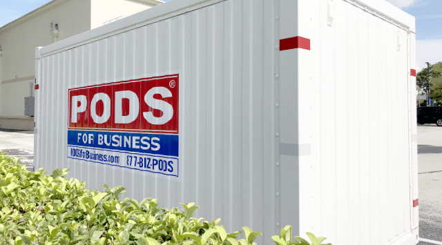 A PODS for Business portable storage container is positioned outside a commercial facility and being used for facilities management storage.