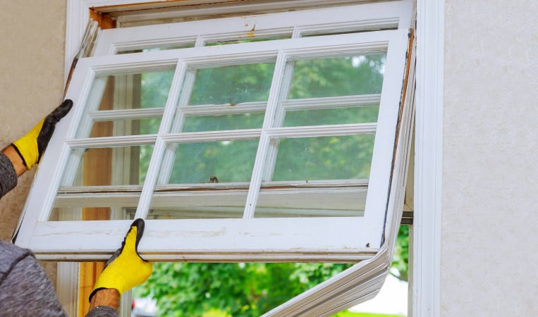someone replacing a window in a home