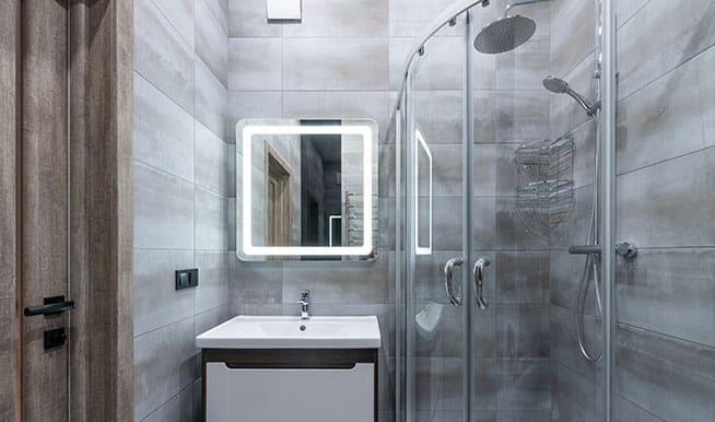A simple, compact walk-in shower. The shower door is rounded,making a small space feel bigger.