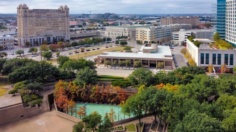 An aerial view of the Fort Worth Water Gardens and surrounding city buildings and greenery.