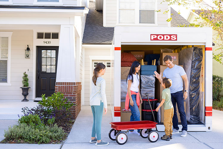 A family of four loading up their PODS container to move to their new home state.