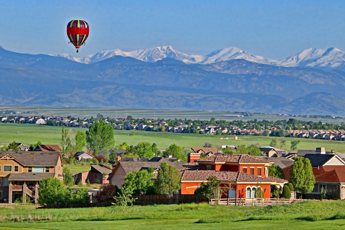 A hot air balloon floats above Erie, Colorado — a suburb of Denver and one of the fastest growing towns in the U.S. in 2024.