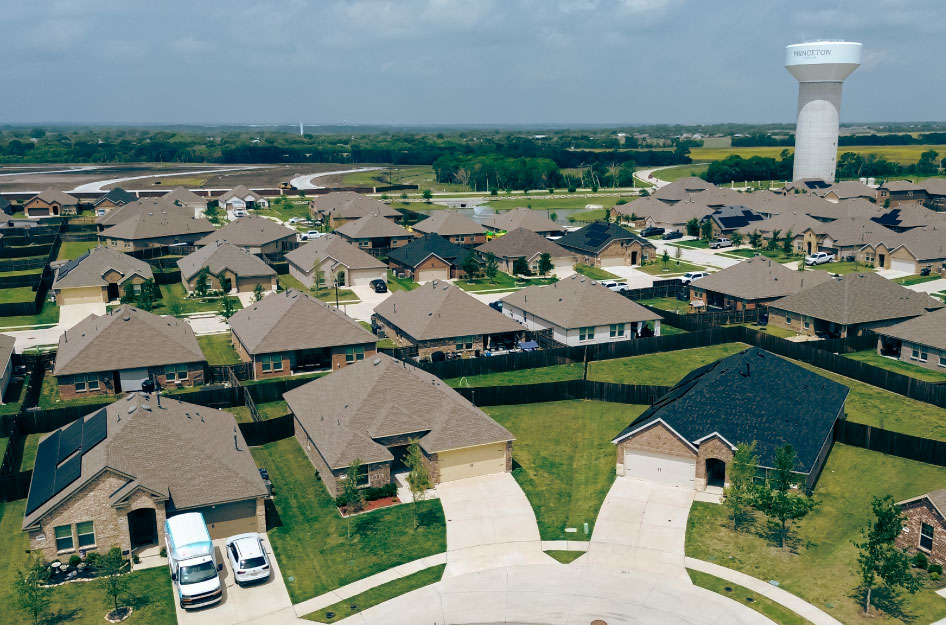 Aerial view of a residential neighborhood in Princeton, TX, with the city’s water tower visible in the distance.