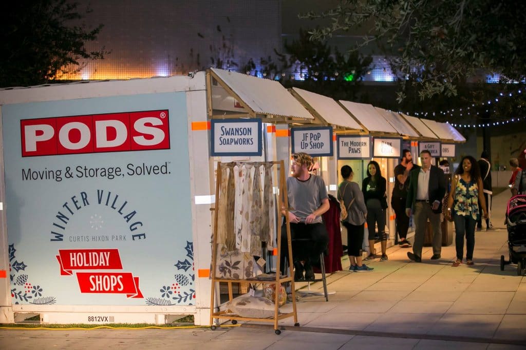 Row of pop up shops inside PODS containers at a winter market