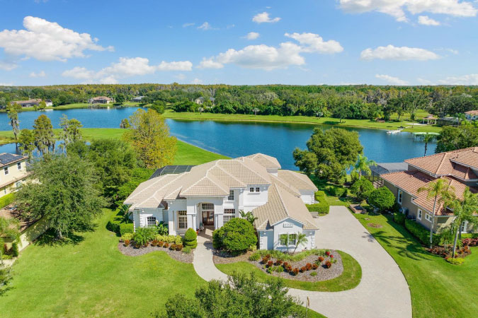 Aerial view of a lakeside wooded community in Odessa — one of the most sought-after cities near Tampa. 