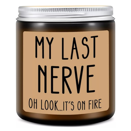A novelty candle in a mason jar with a silver lid, labeled “My last nerve, oh look it’s on fire.”