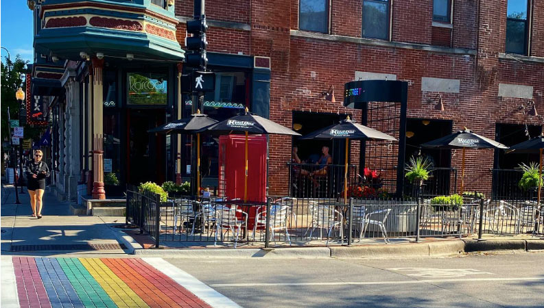The view across a street in Northalsted, featuring a rainbow-painted crosswalk.