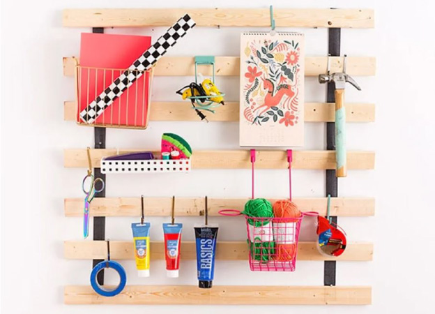 IKEA bed slats hung on a wall for vertical storage.