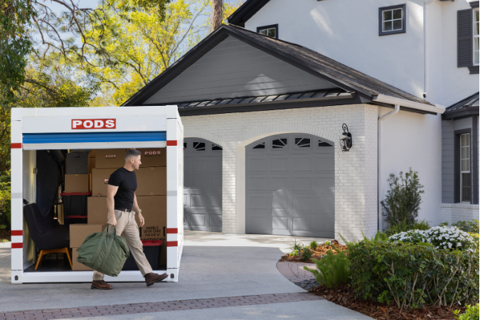 A young military serviceman unloads his PODS container in the Jacksonville neighborhood of Orange Park.