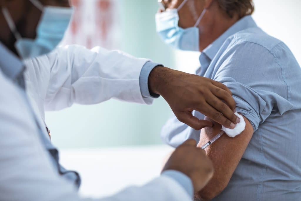 Man receiving an injection of the COVID-19 vaccine