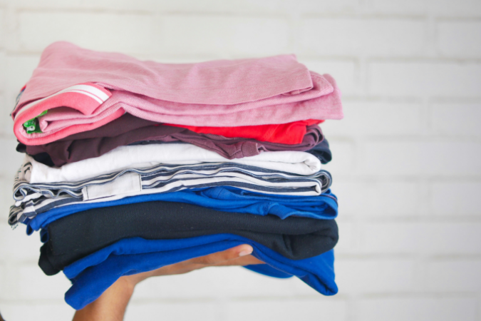 A pile of neatly folded clothes. This is the best method for packing clothes when moving.