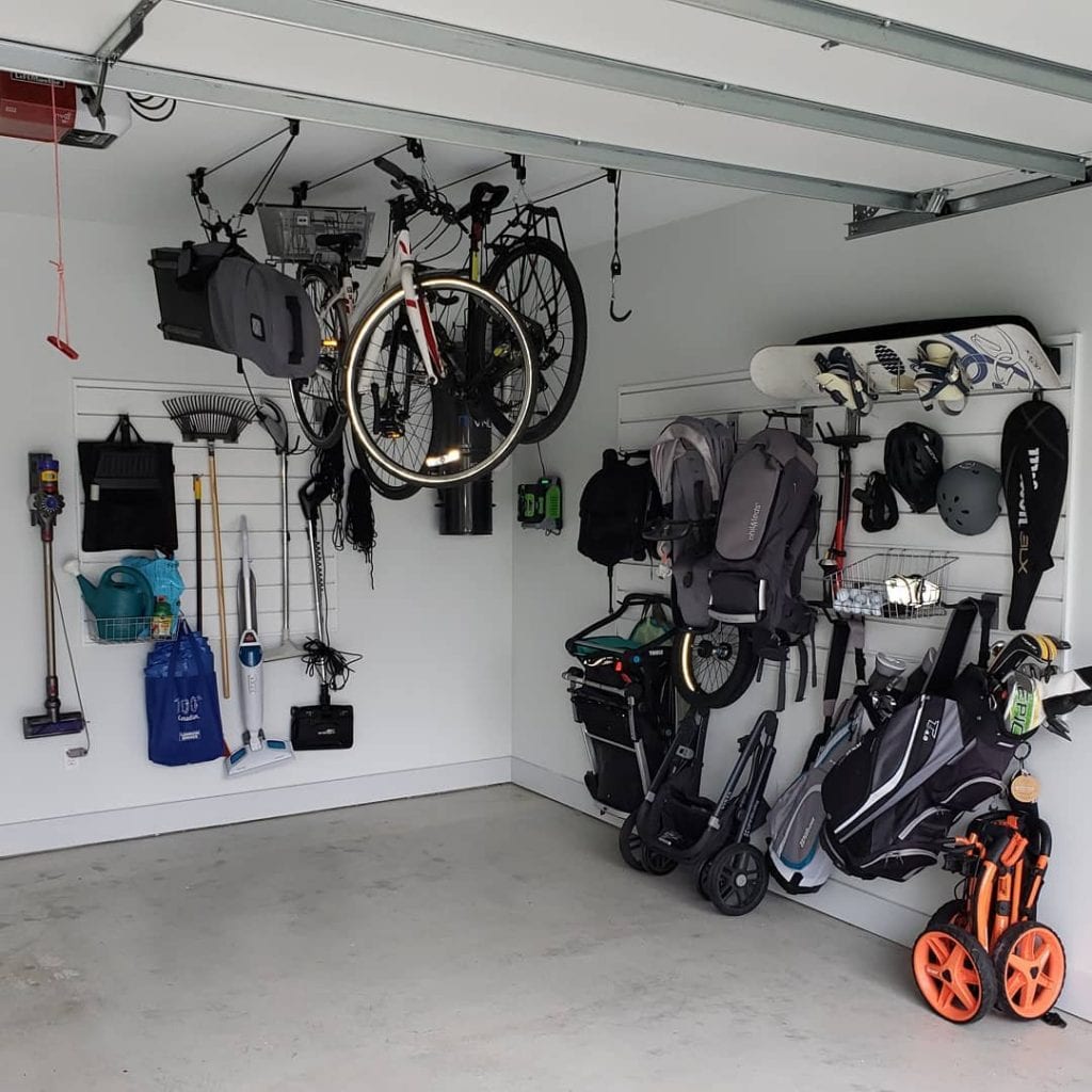 Items in a garage hag vertically from the wall and ceiling to allow for more storage.