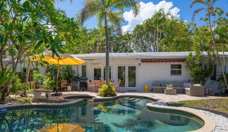 View from the backyard of a classic Old-Florida home in the Victoria Park neighborhood of Fort Lauderdale, Florida.