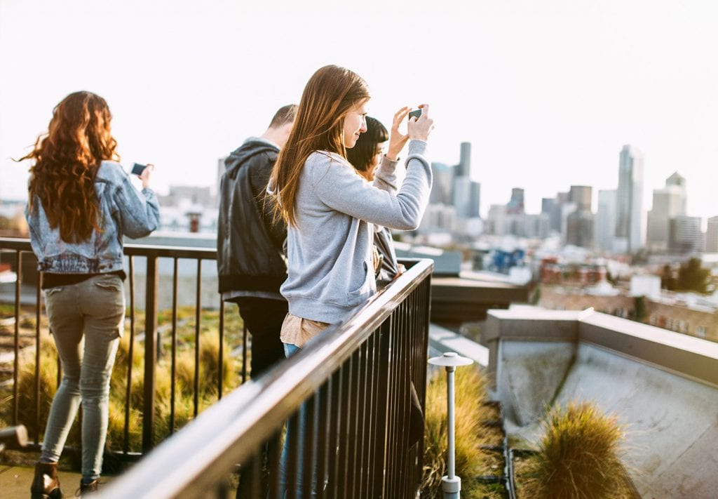 A group of young friends taking photos of downtown Seattle