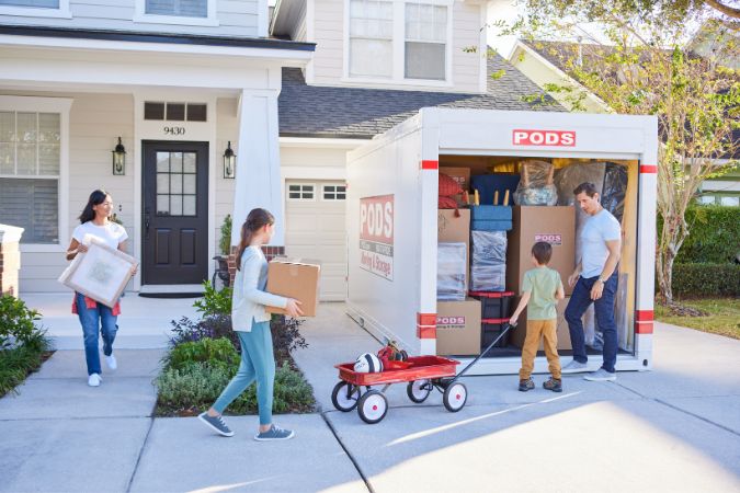 A family loading their 16-foot PODS storage container, which is about the equivalent of a 10'x15' self-storage unit.