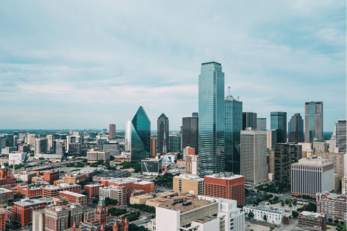 The skyline of Dallas, TX during the day. Dallas is one of the best places in Texas to live.