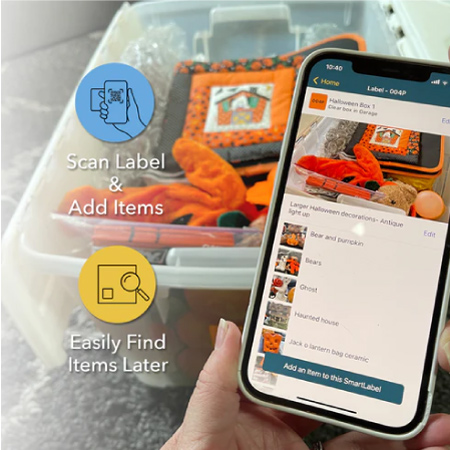 Image of a hand holding a phone with organized labels and a box of things in the background