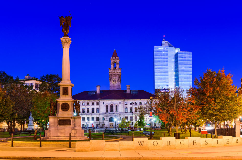 View of Worcester City Hall in Worcester, Massachusetts, against a dark blue sky.
