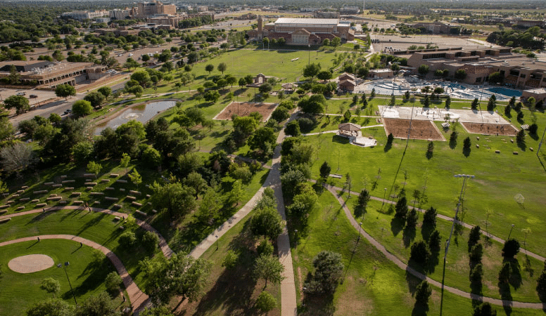 Aerial afternoon view of the Texas Tech University campus in Lubbock, Texas, with parts of the city visible in the background.