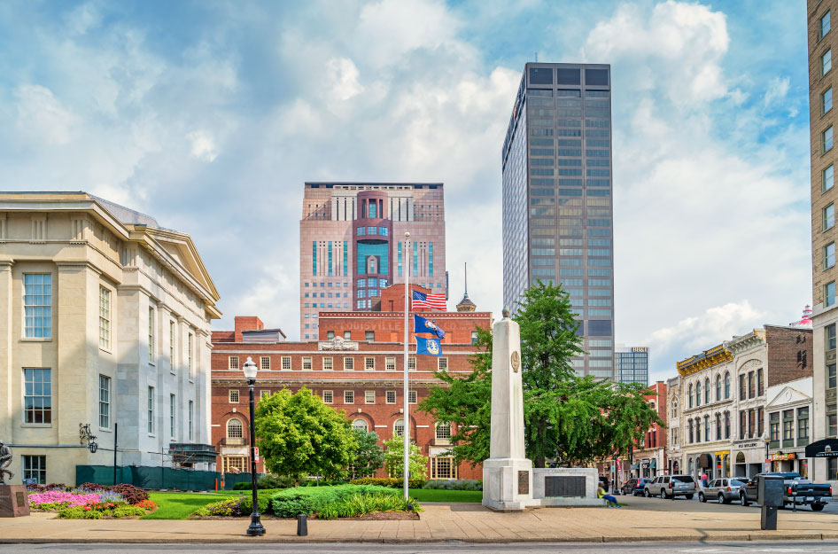Street-level view of Jefferson Street and Town Square in Downtown Louisville, Kentucky, on a cloudy day.