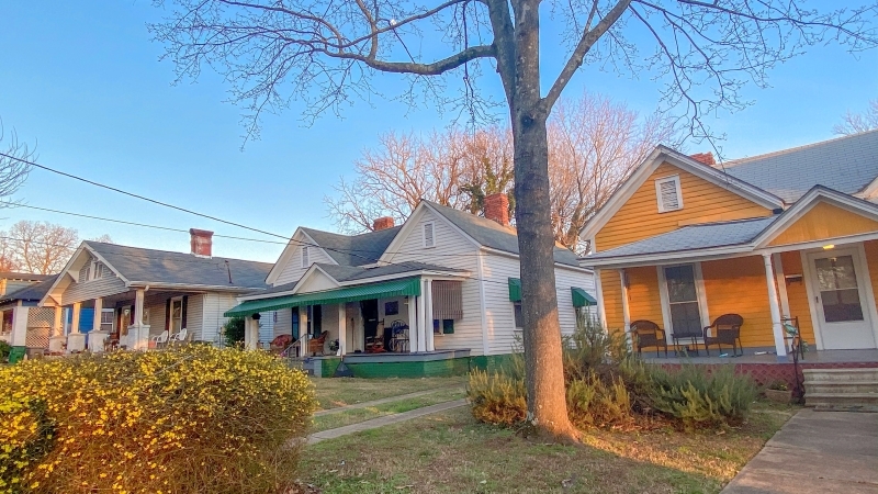 A row of single-story, brightly colored bungalows in Charlotte's Belmont neighborhood.