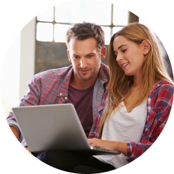 a couple sitting and looking at quotes on a laptop together