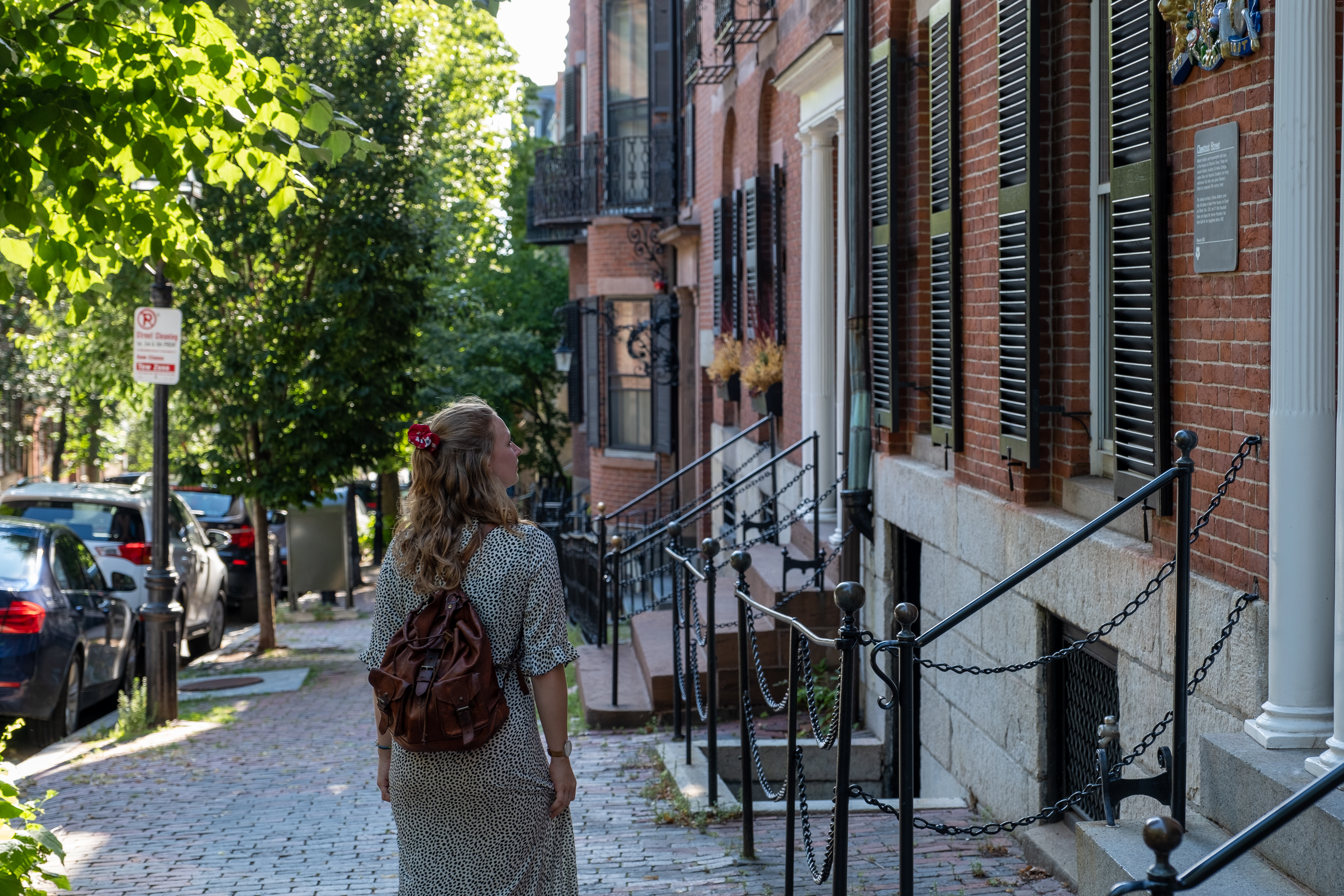 Someone walking down a Boston sidewalk and looking at the buildings