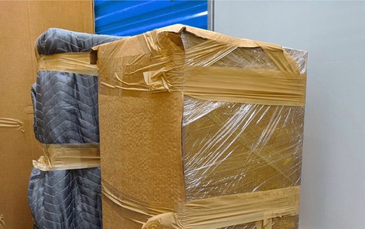 Repurposed moving boxes are used to protect furniture during a move.