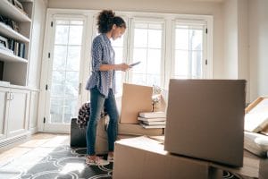 Woman packing boxes for a corporate relocation move