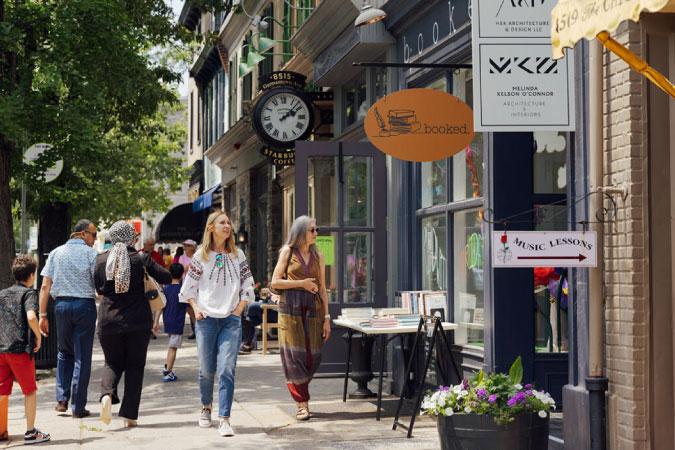 Locals walk leisurely past shops and boutiques in Philadelphia, Pennsylvania — one of the most walkable cities in the U.S.