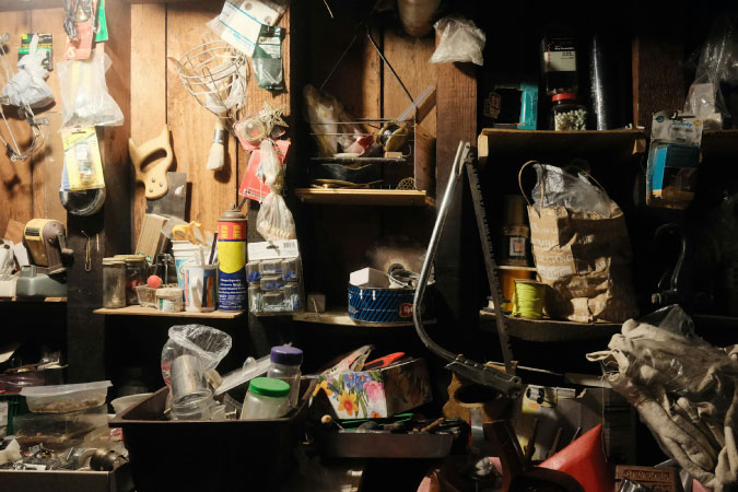 An outdoor storage shed is cluttered with tools and equipment and in desperate need of proper shed organization.
