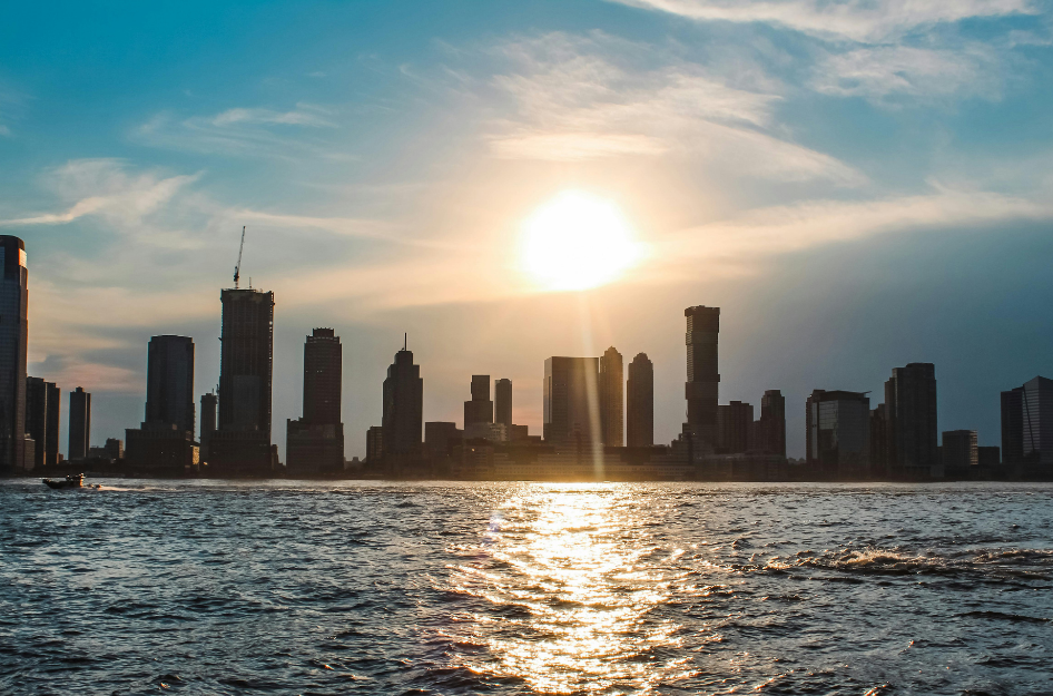 A generic image of a city skyline backlit by the sun.
