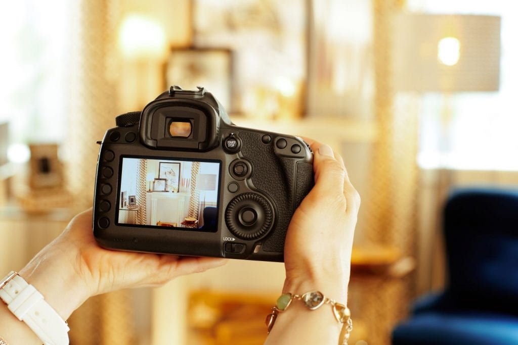  Close-up of a digital camera being used to take photos of furniture and other belongings before a move.