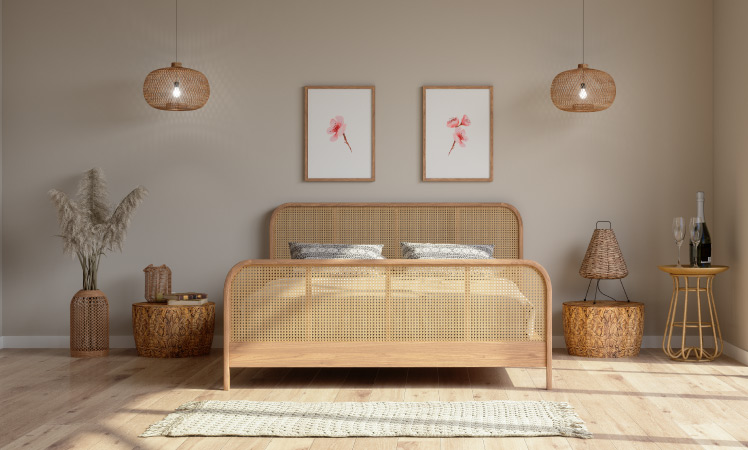 A bedroom that has been arranged according to feng shui. There is symmetry in the placement of furniture and hanging lamps, natural light is streaming in from a window, and the wicker bed is positioned for optimal comfort. 