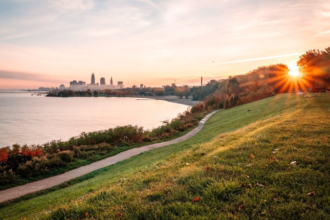 Sunset view from a grassy hill of the Cleveland, Ohio, skyline.