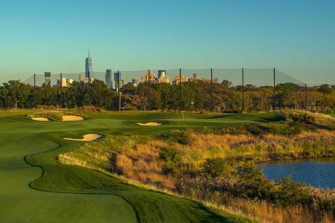 Skyway Golf Course in Jersey City’s West Side, with green fairways, sand bunkers, and the Manhattan skyline in the distance, highlighting outdoor space in Jersey City neighborhoods.