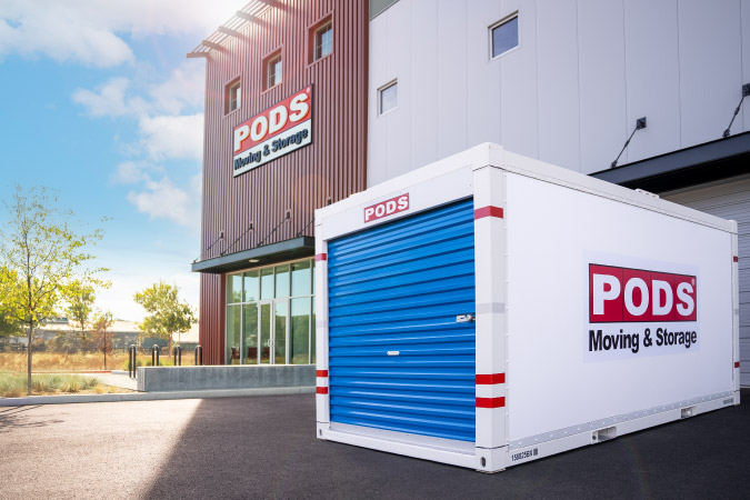 PODS moving and storage costs include one month of storage, either on your property or inside a secure PODS Storage Center (pictured in the image with a PODS container parked outside).