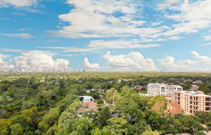 An elevated view over the Washington Ave Coalition - Memorial Park neighborhoods in Houston, Texas, on a beautiful summer day.
