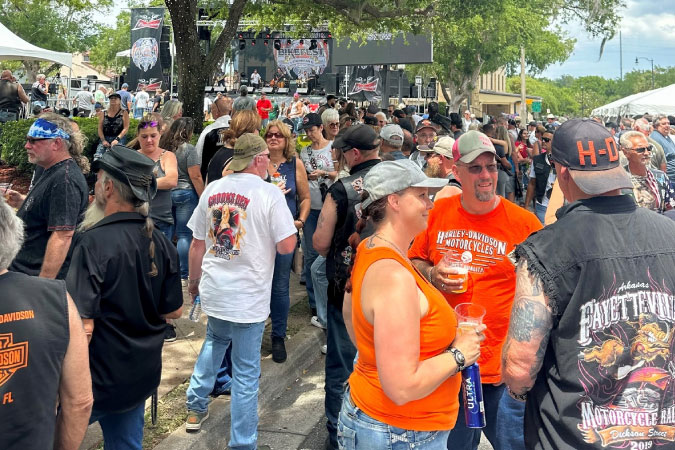Tourists crowd the city streets during a musical performance at the Leesburg Bikefest in Leesburg, Florida.