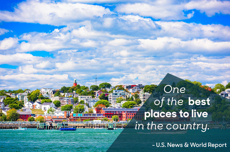 View of the beautiful and vibrant city of Portland, Maine, on a sunny summer day, as seen from the water. The overlaid text reads “One of the best places to live in the country. -U.S. News & World Report”.