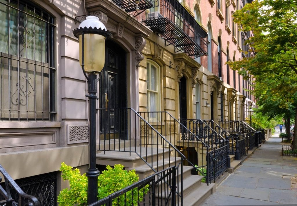A view of some of the brownstone facades lining one of the streets in the East Village of Manhattan.