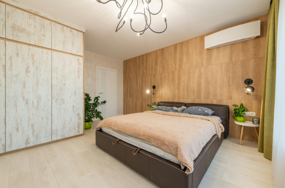 A brightly lit bedroom with colorful bedding oriented for the best way to practice bedroom feng shui.