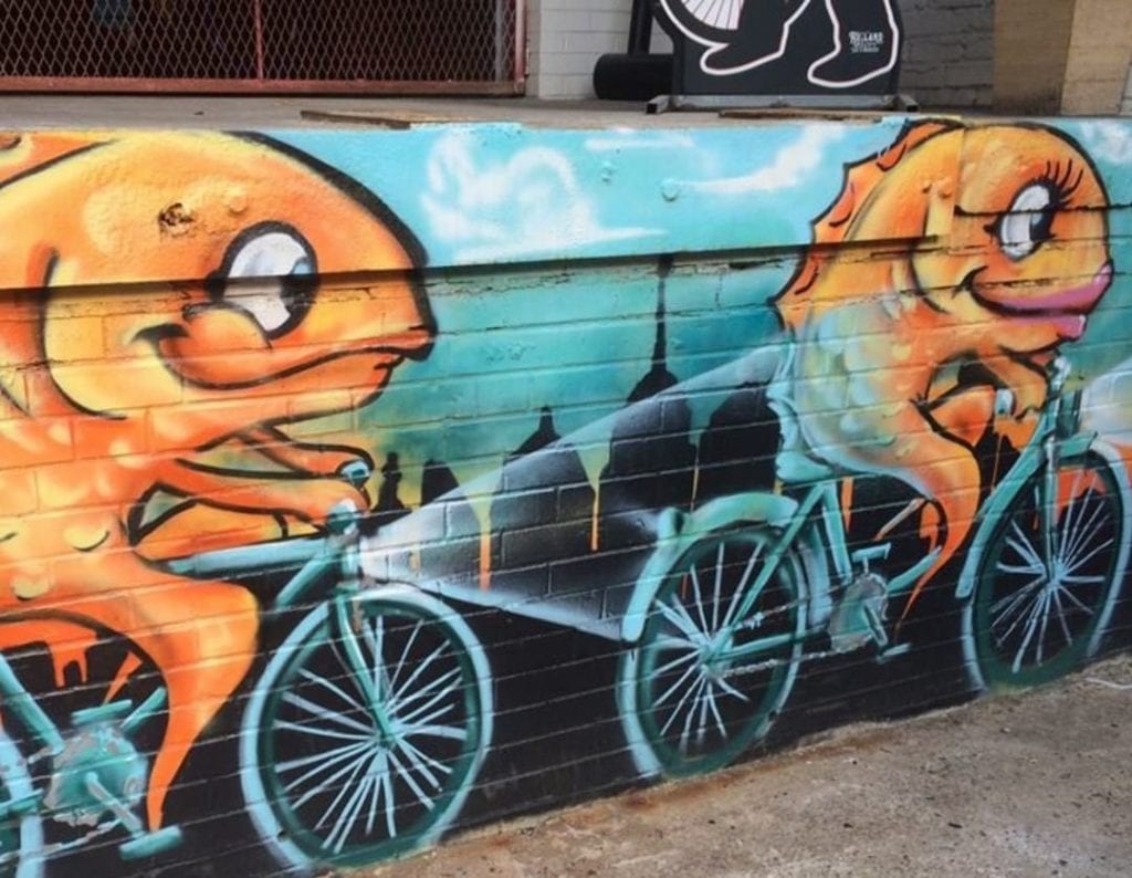 A mural of two goldfish riding bicycles, painted on a wall in Fishtown, one of the trendiest Philadelphia neighborhoods.